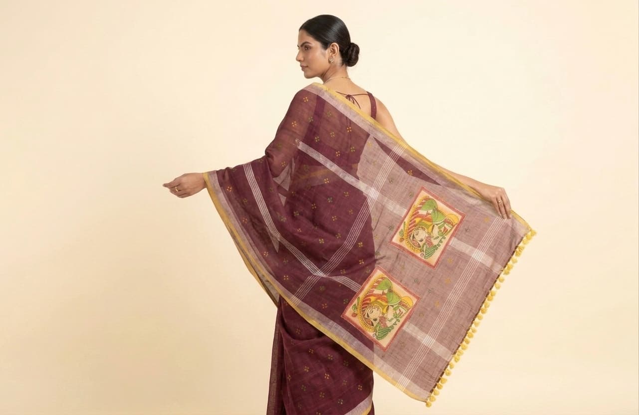 Merlot georgette saree, back view with the pallu held open to show the Pichwai-art patch squares